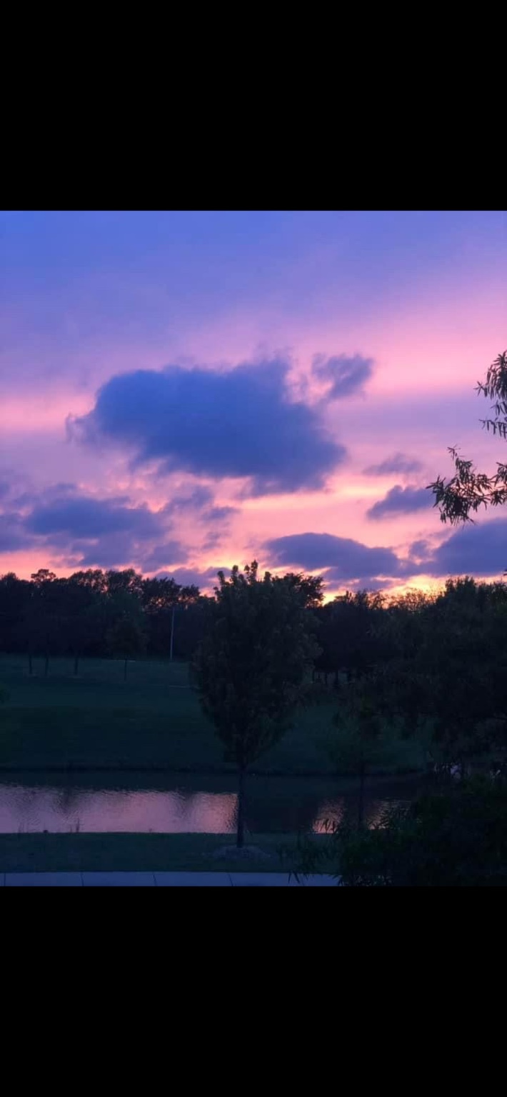 A violet and pink evening sky over Fayetteville, photographed by Adrian.