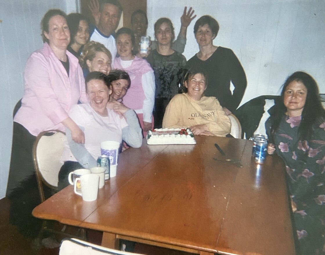 Adrian at nineteen, crouching in the center of a group at the transitional living and re-entry program where she worked.